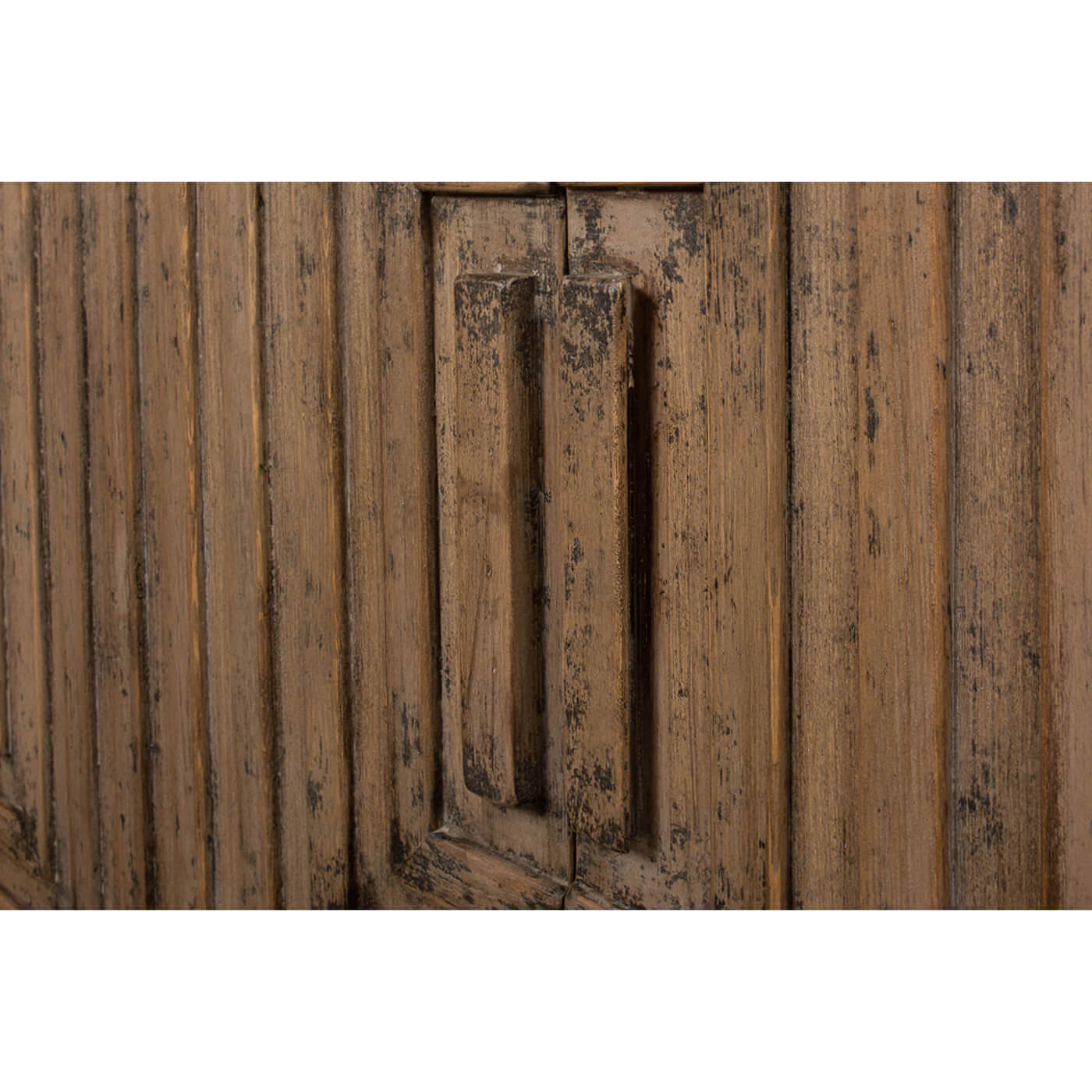 Close-up of handles on geometric cabinet doors.