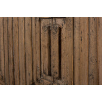 Close-up of handles on geometric cabinet doors.