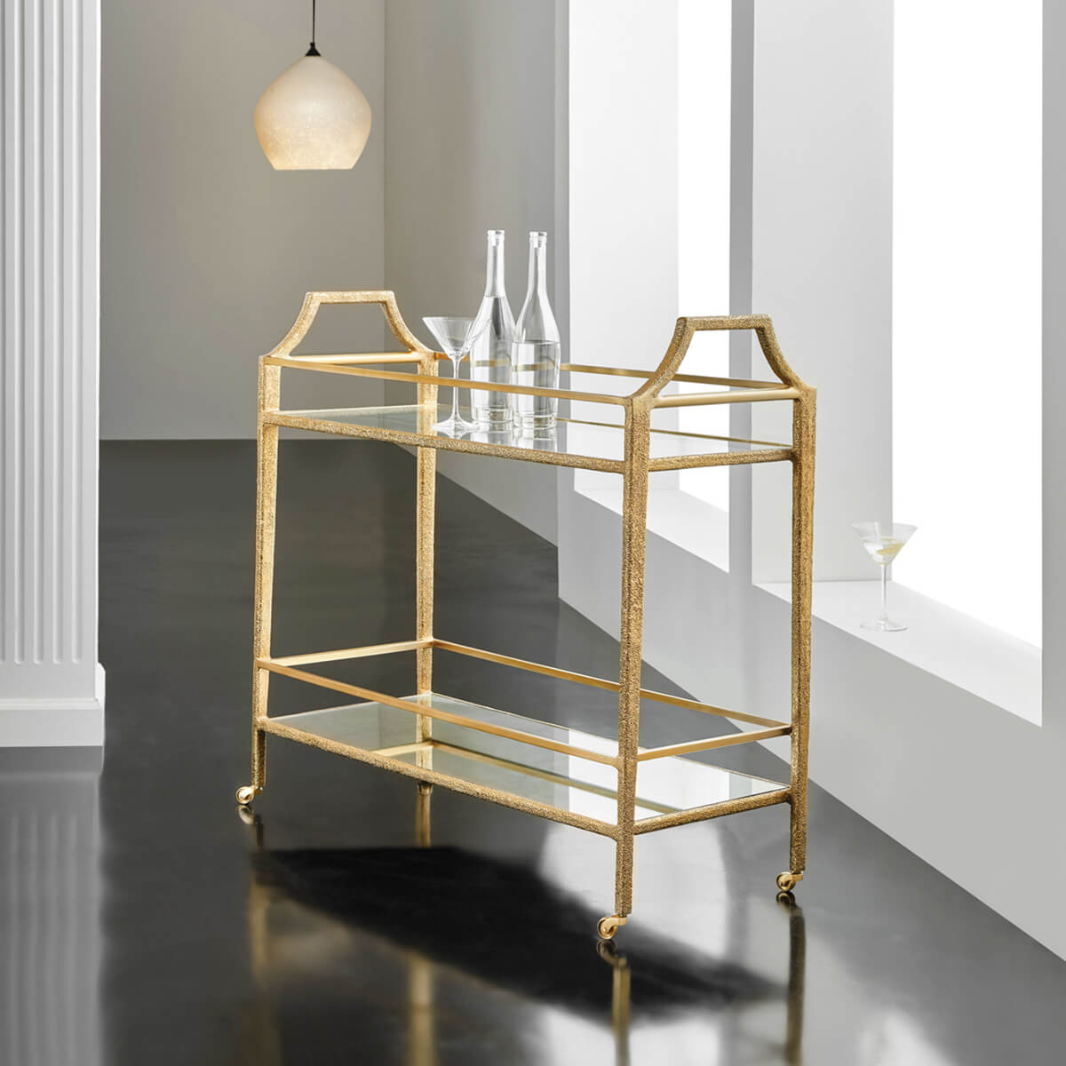 Gold bar cart in a modern interior setting.