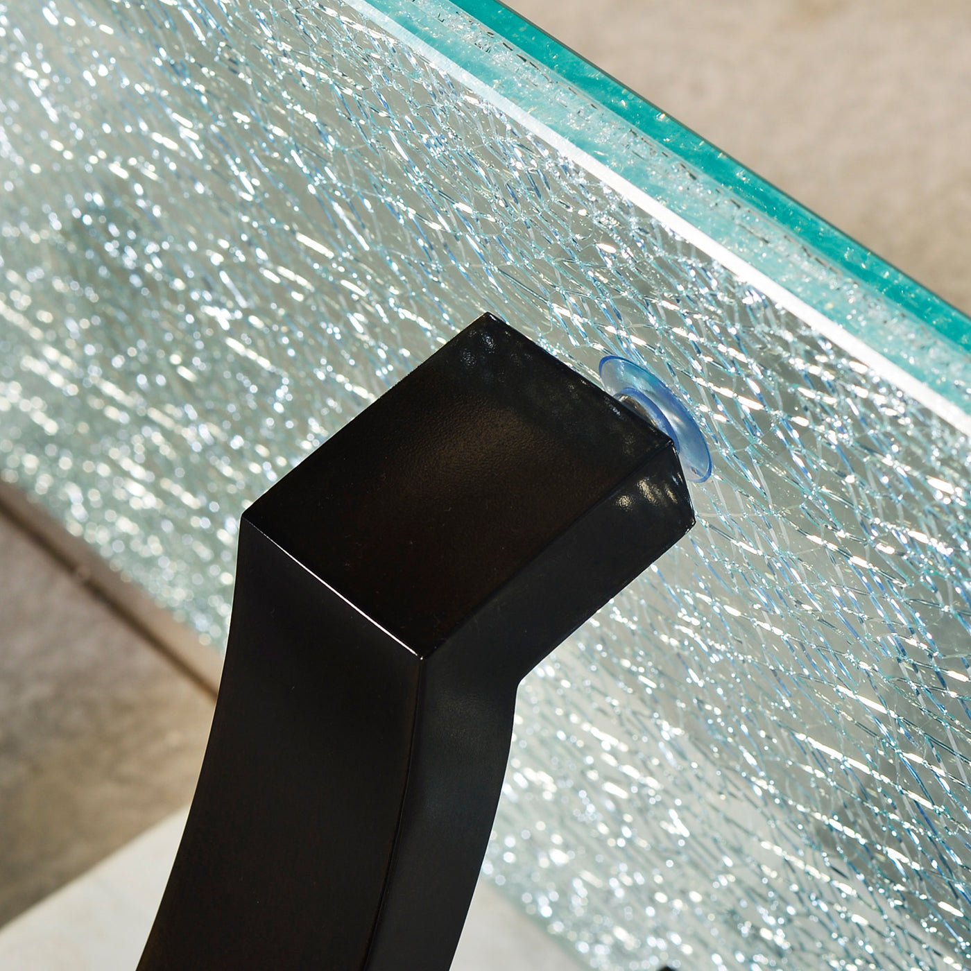 Glass top attachment detail on console table base.