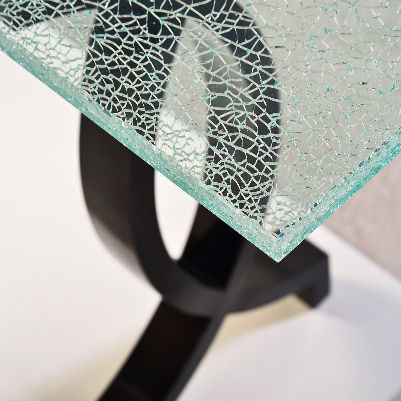 Close-up of cracked glass top on console table.