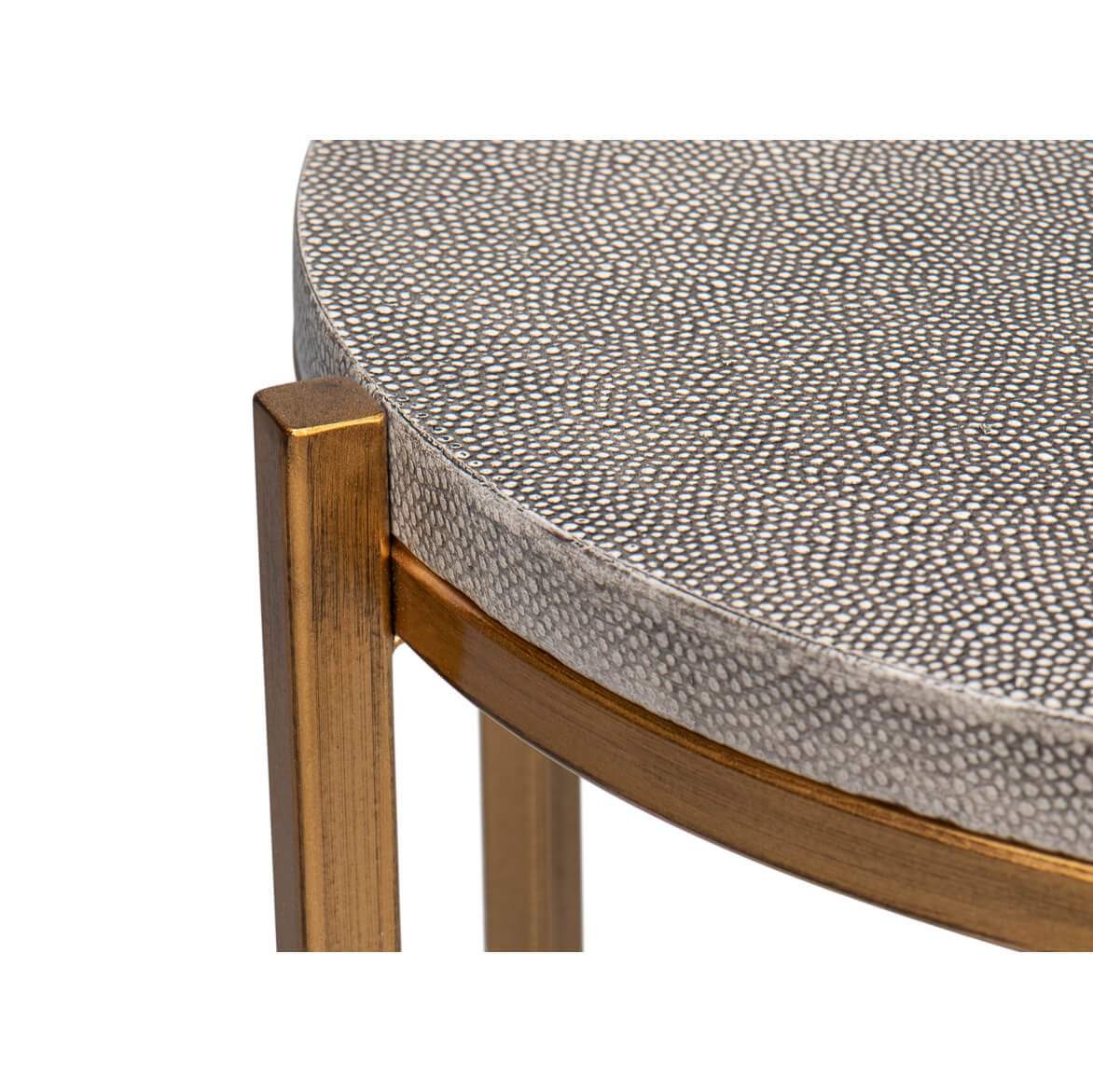 Edge detail of modern gray leather accent table.