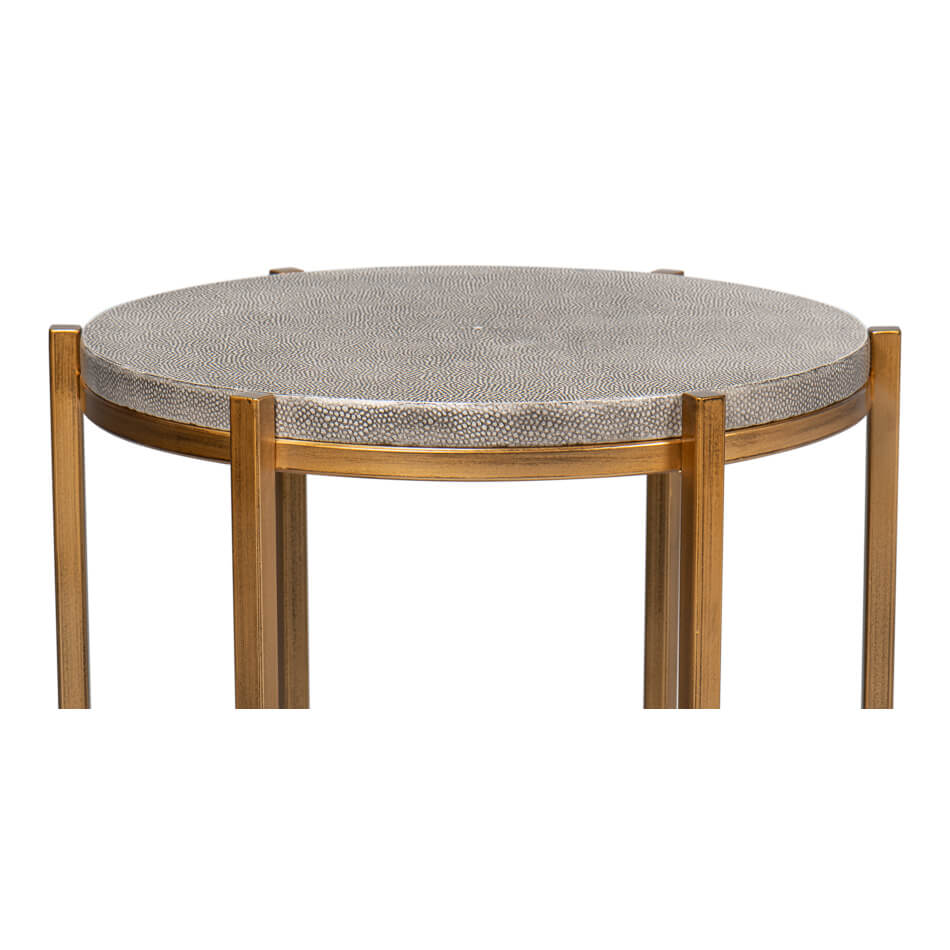 Side detail of round gray leather accent table.