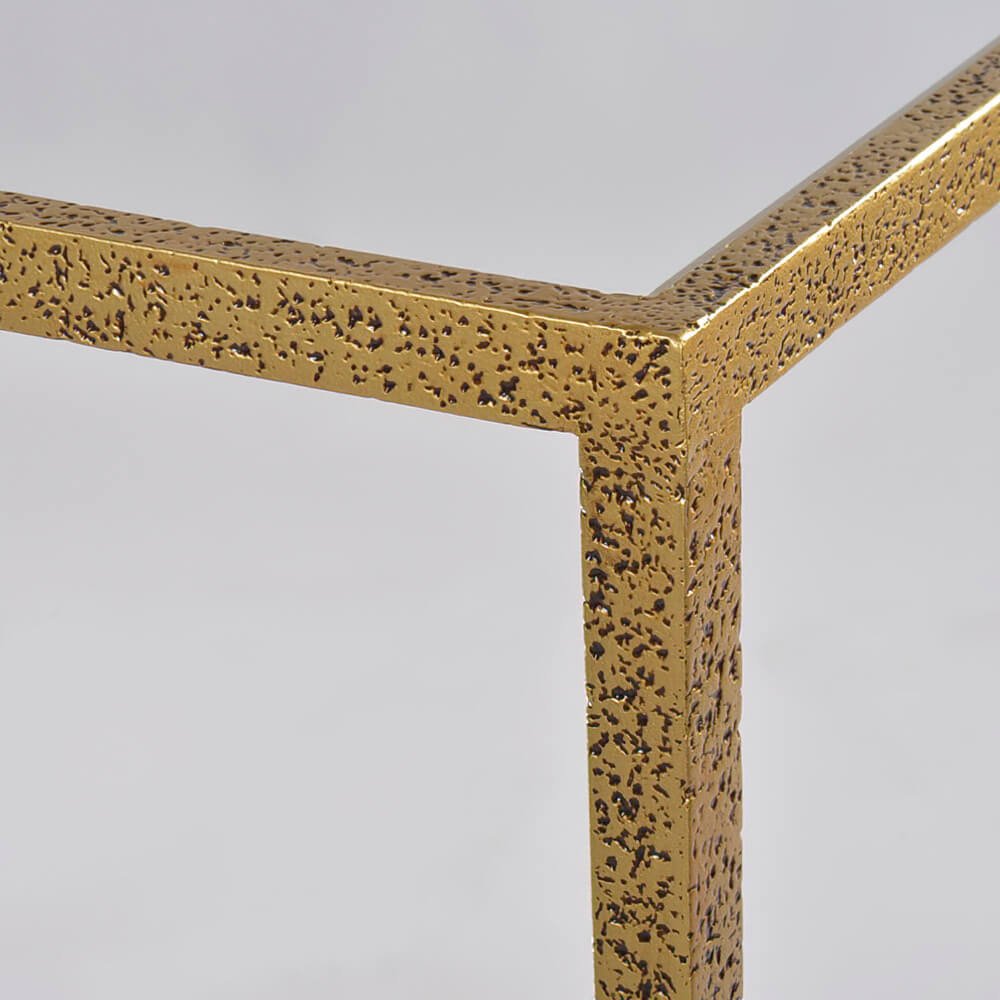 Close-up of gold textured frame on side table.