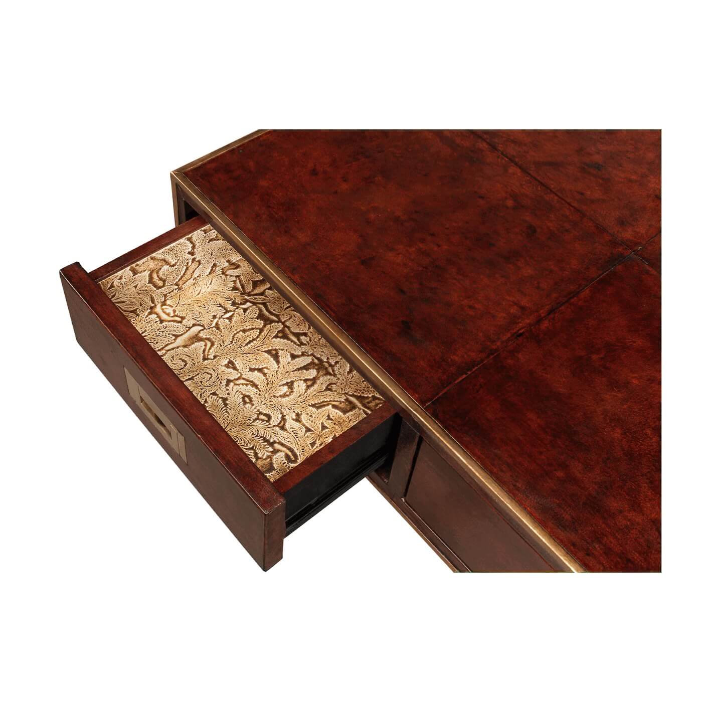 Open drawer with patterned lining on leather desk.