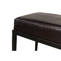 Detailed view of bench corner leather and iron texture.