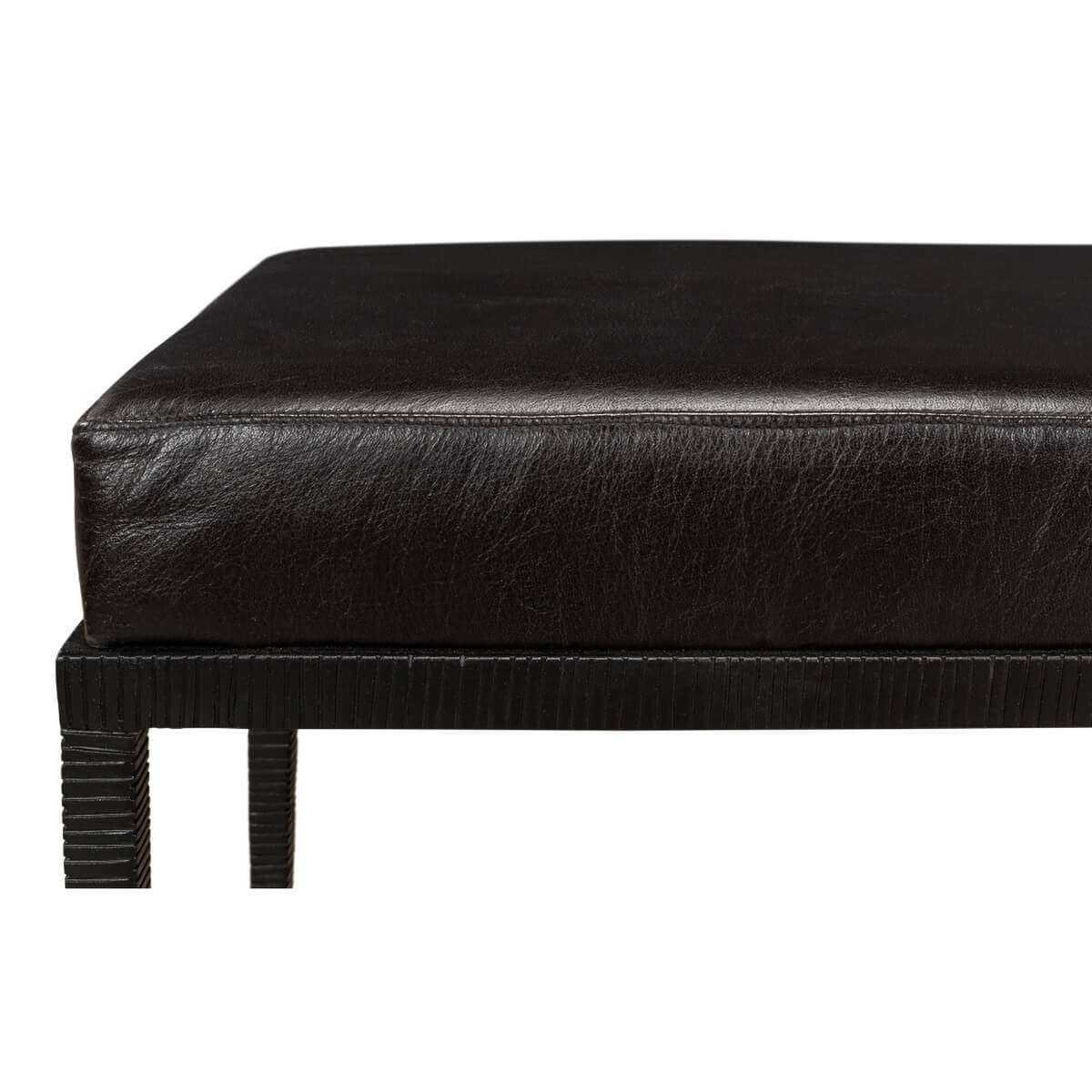 Close-up of leather cushion and iron frame detail.