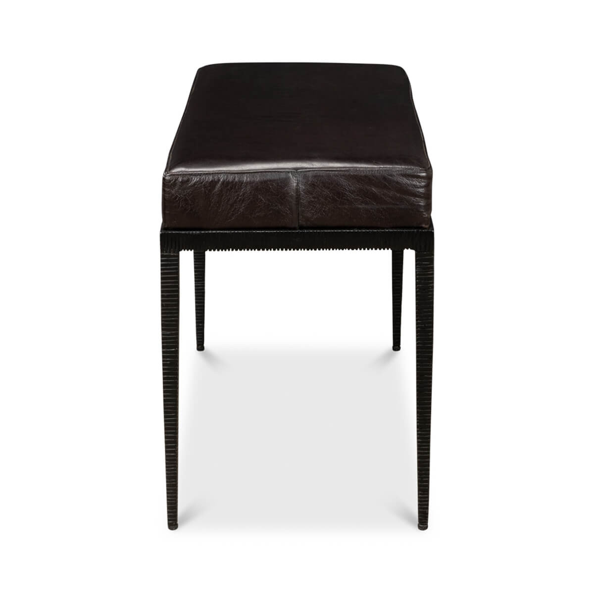 End-on view of iron and leather bench.