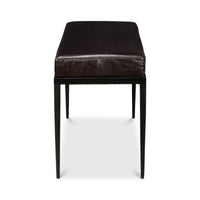 End-on view of iron and leather bench.