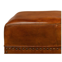 Top edge of ottoman showcasing smooth leather finish.