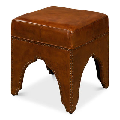 Brown leather ottoman with detailed arching base design.