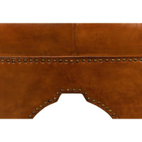 Detailed close-up of ottoman base, rivet accents.