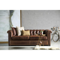 Brown leather Chesterfield sofa in styled room setting
