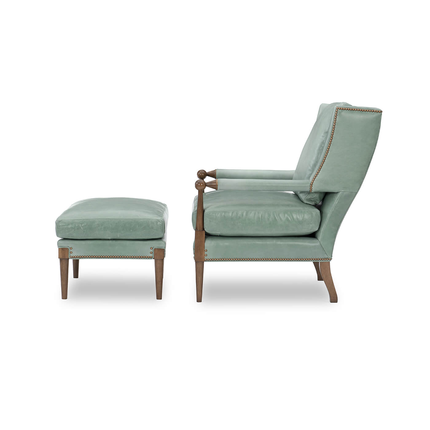 Side profile of green armchair and ottoman.