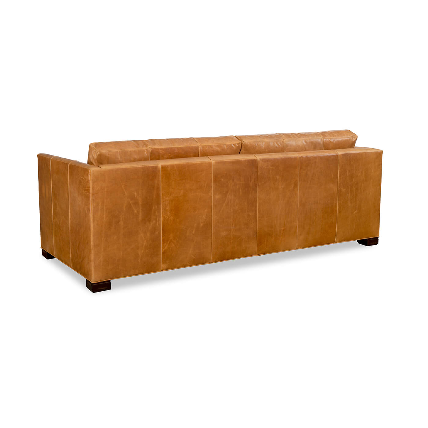 Back of tan leather sofa, clean lines, wooden legs.