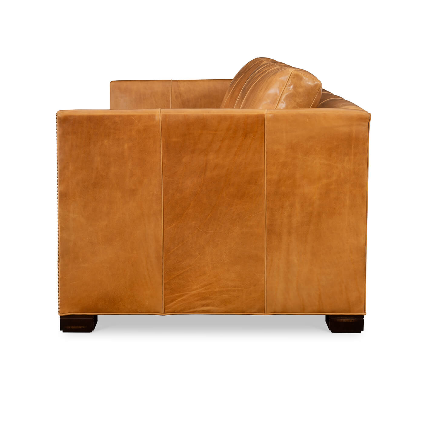 Side view, tan leather sofa, structured armrest.