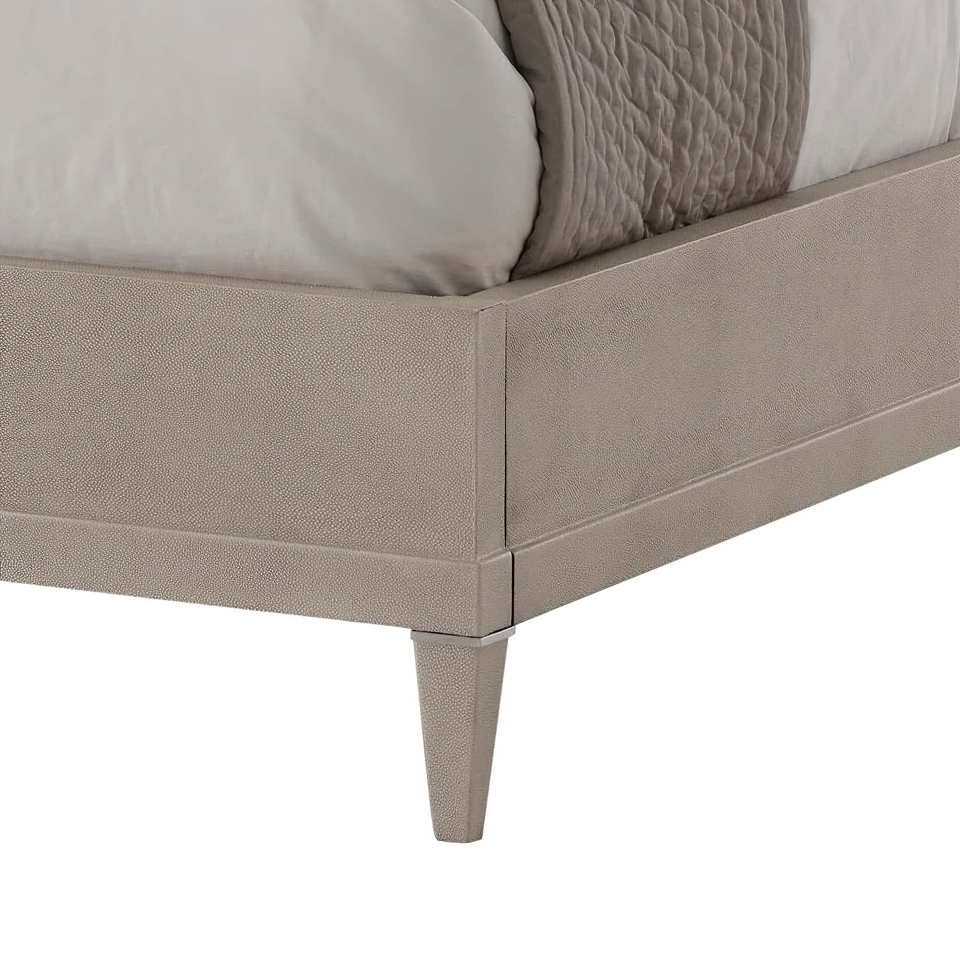 Close-up of modern leather wrapped bed frame corner.