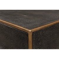 Corner close-up of dresser, textured leather and metal trim.