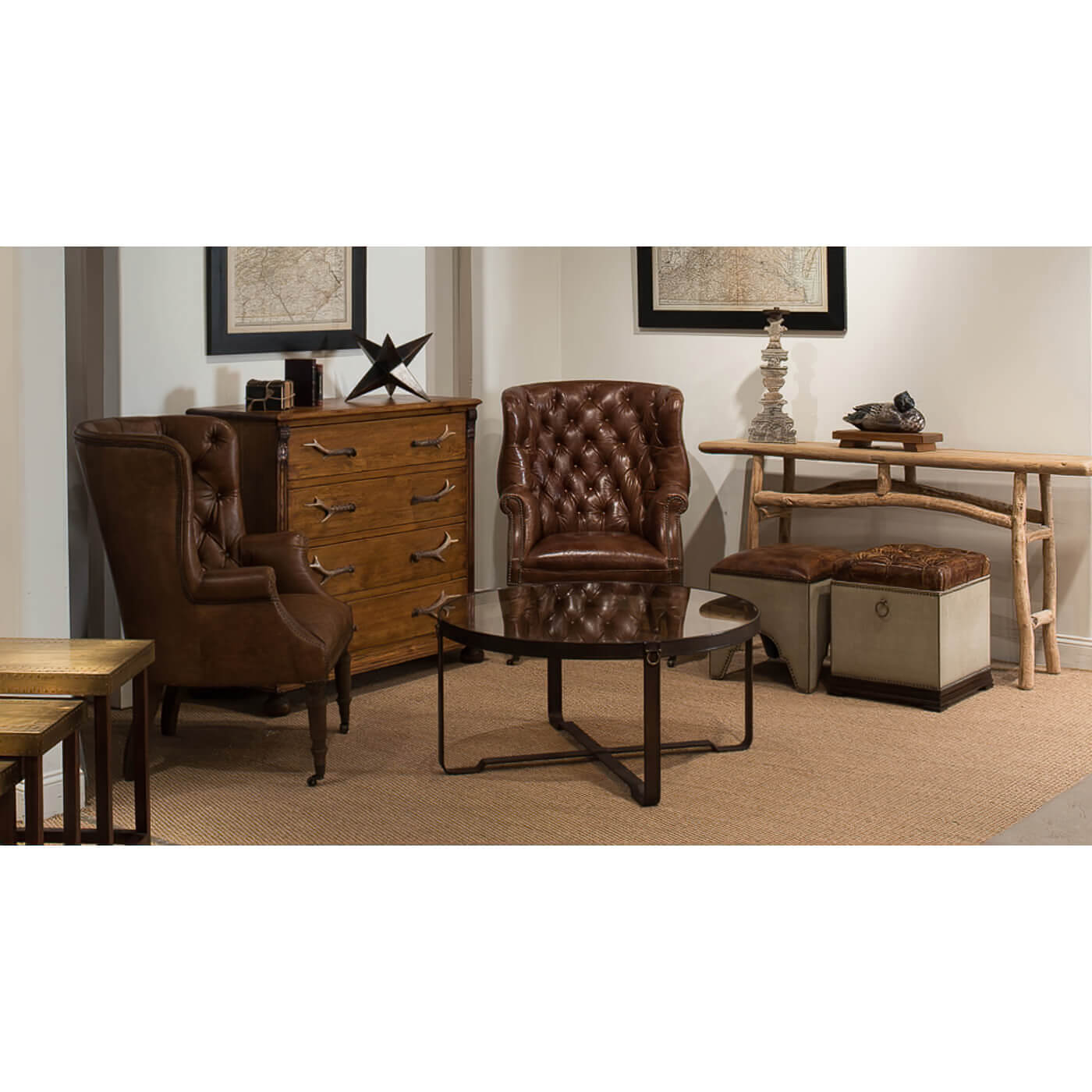 Coffee table in living room with leather chairs and decor.