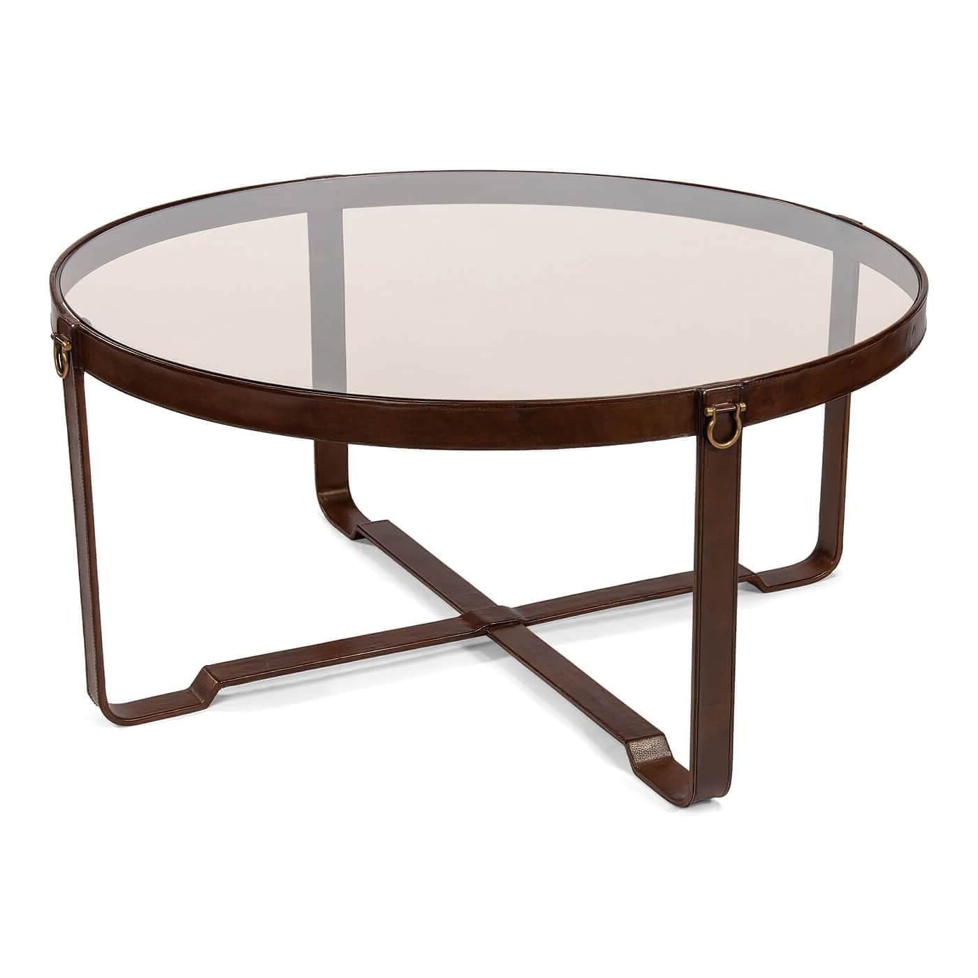Round coffee table with glass top and leather detail.
