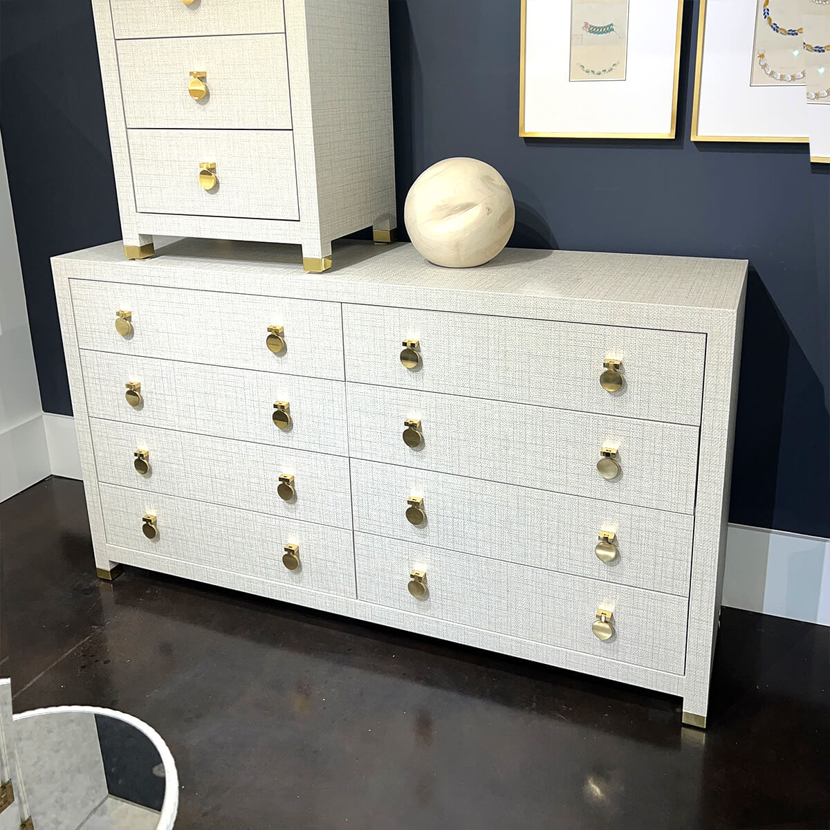 Weaved gray dresser against dark wall, styling details.