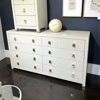Weaved gray dresser against dark wall, styling details.