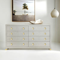 Modern dresser in room, with art and pendant light.