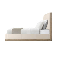 Side view of oak and leather upholstered bed.