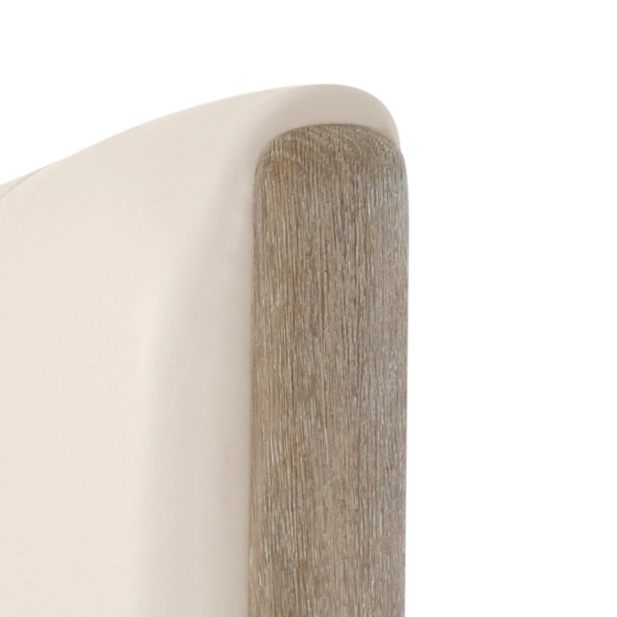 Close-up of oak finish on upholstered bed corner.