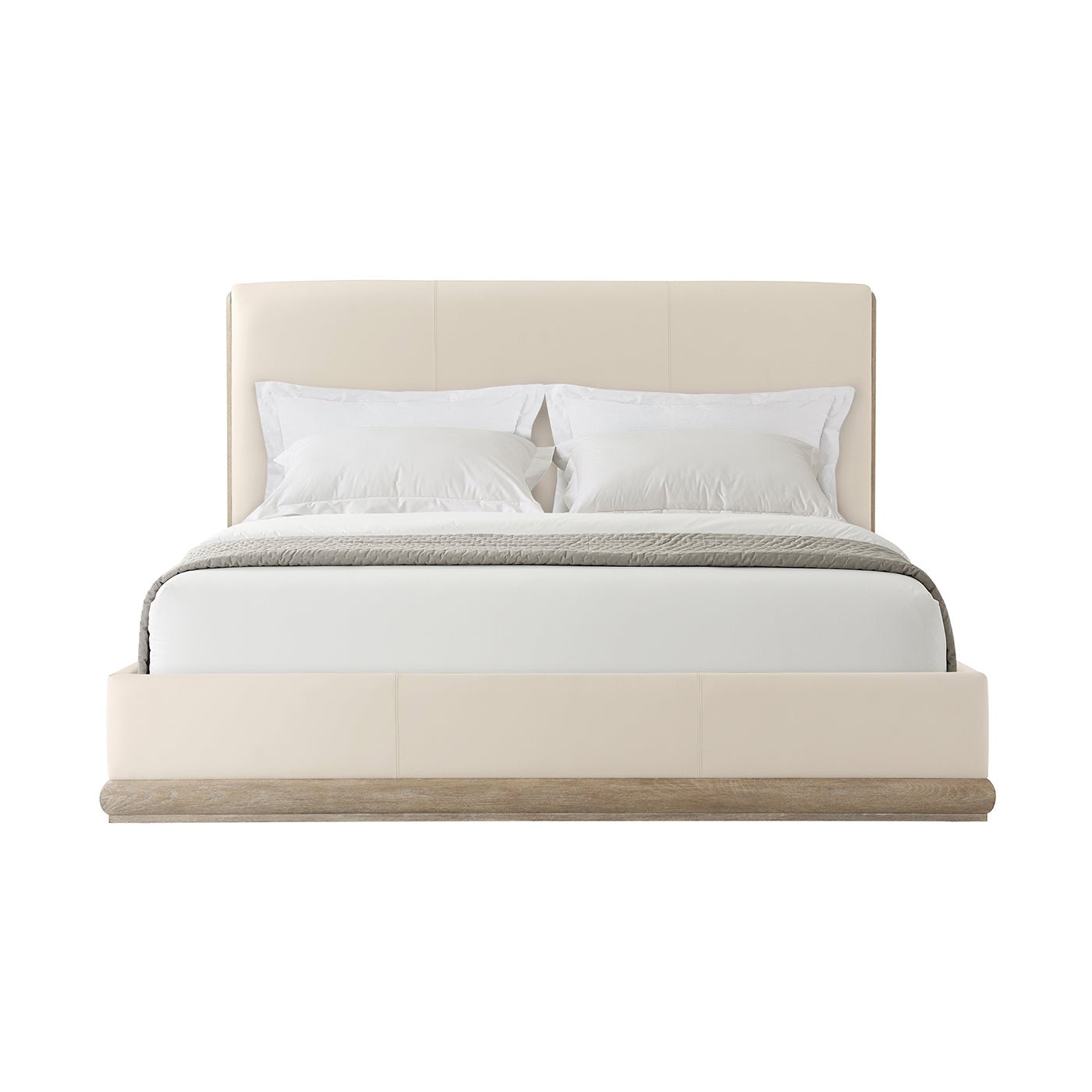 Front view of leather upholstered bed with pillows.