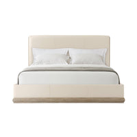Front view of leather upholstered bed with pillows.