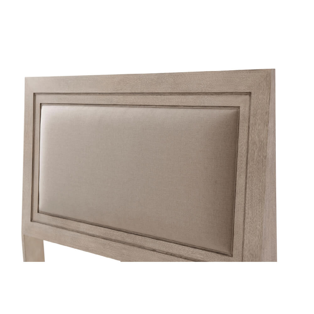 Detailed view of upholstered headboard on king size bed.