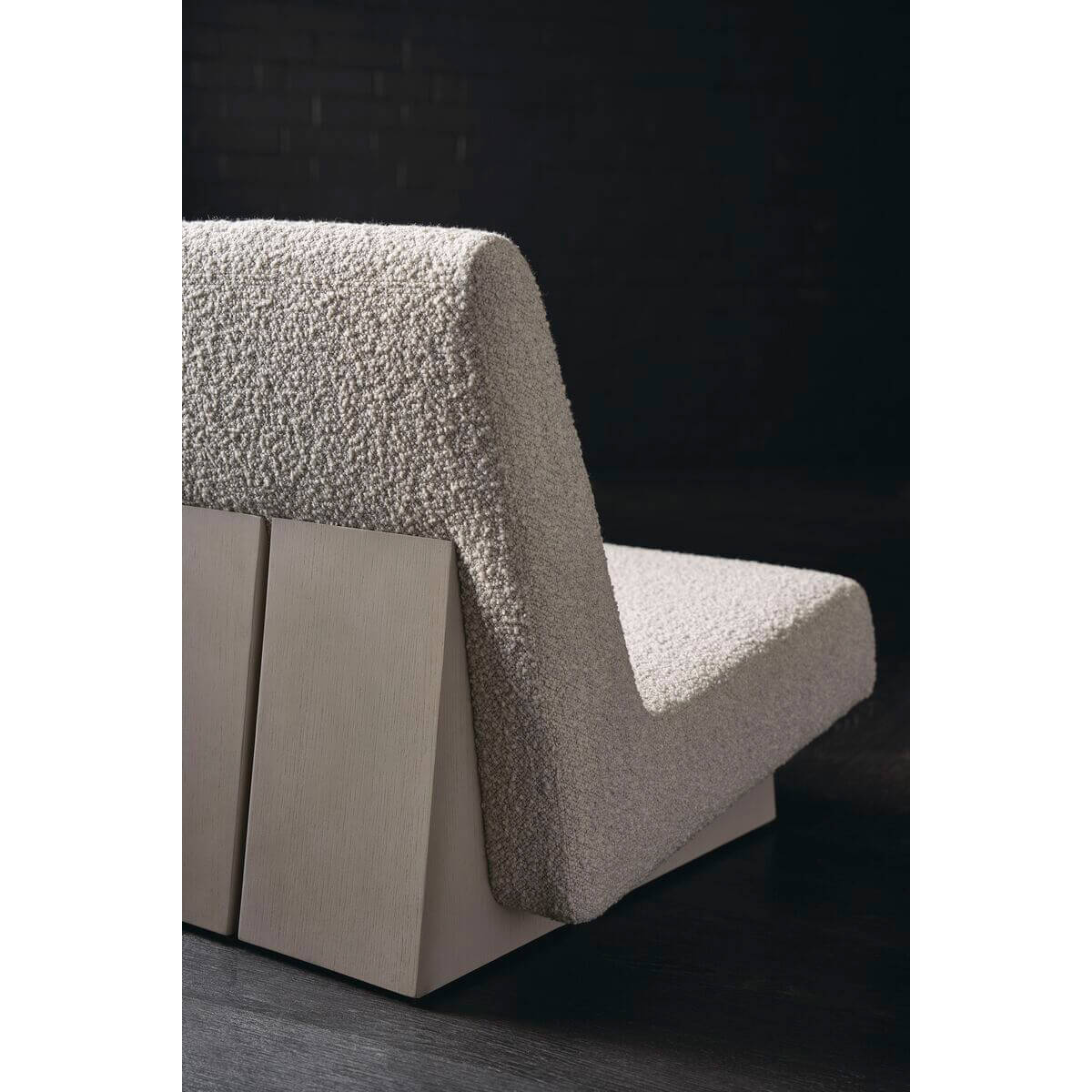 Close-up of modern low accent chair's texture and base.