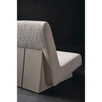 Close-up of modern low accent chair's texture and base.