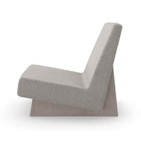 Side profile of modern low accent chair with slanted back.