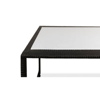 Edge detail of modern marble top iron coffee table.