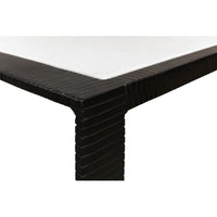Close-up corner detail of modern marble top iron coffee table.
