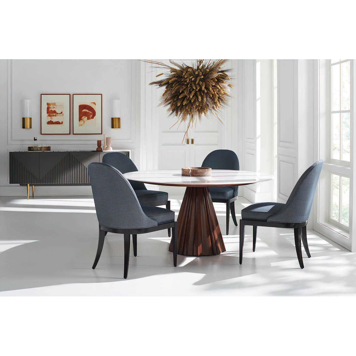 Dining table with black chairs, bright room.