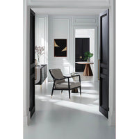 Dining table seen through open doors, modern decor.