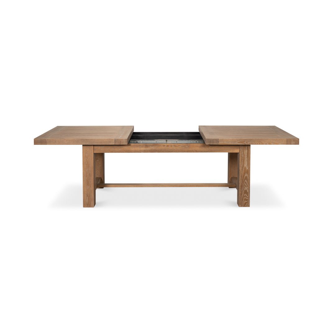 Oak dining table, open with extension leaf visible.