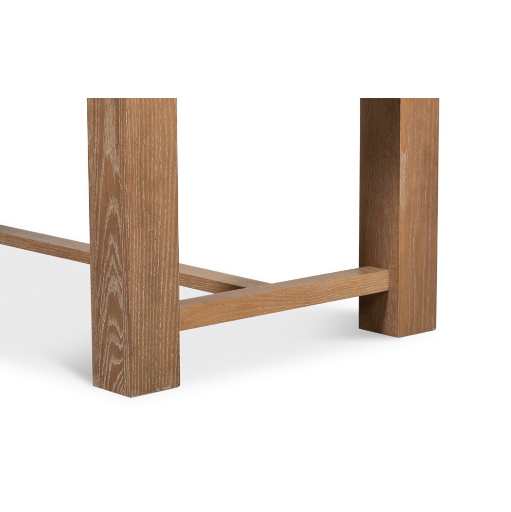 Dining table leg detail, showing wood texture.