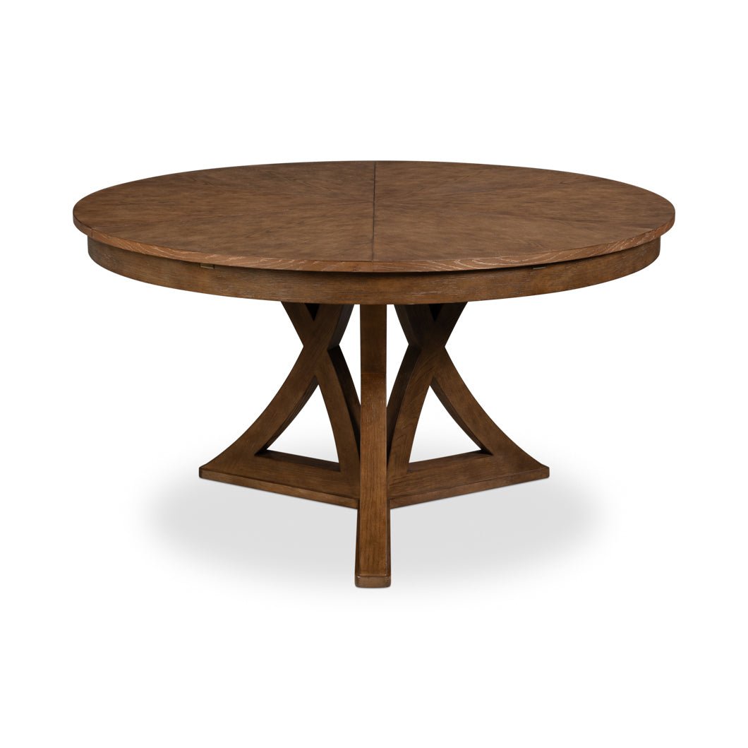 Round wooden dining table, unextended with pedestal base.