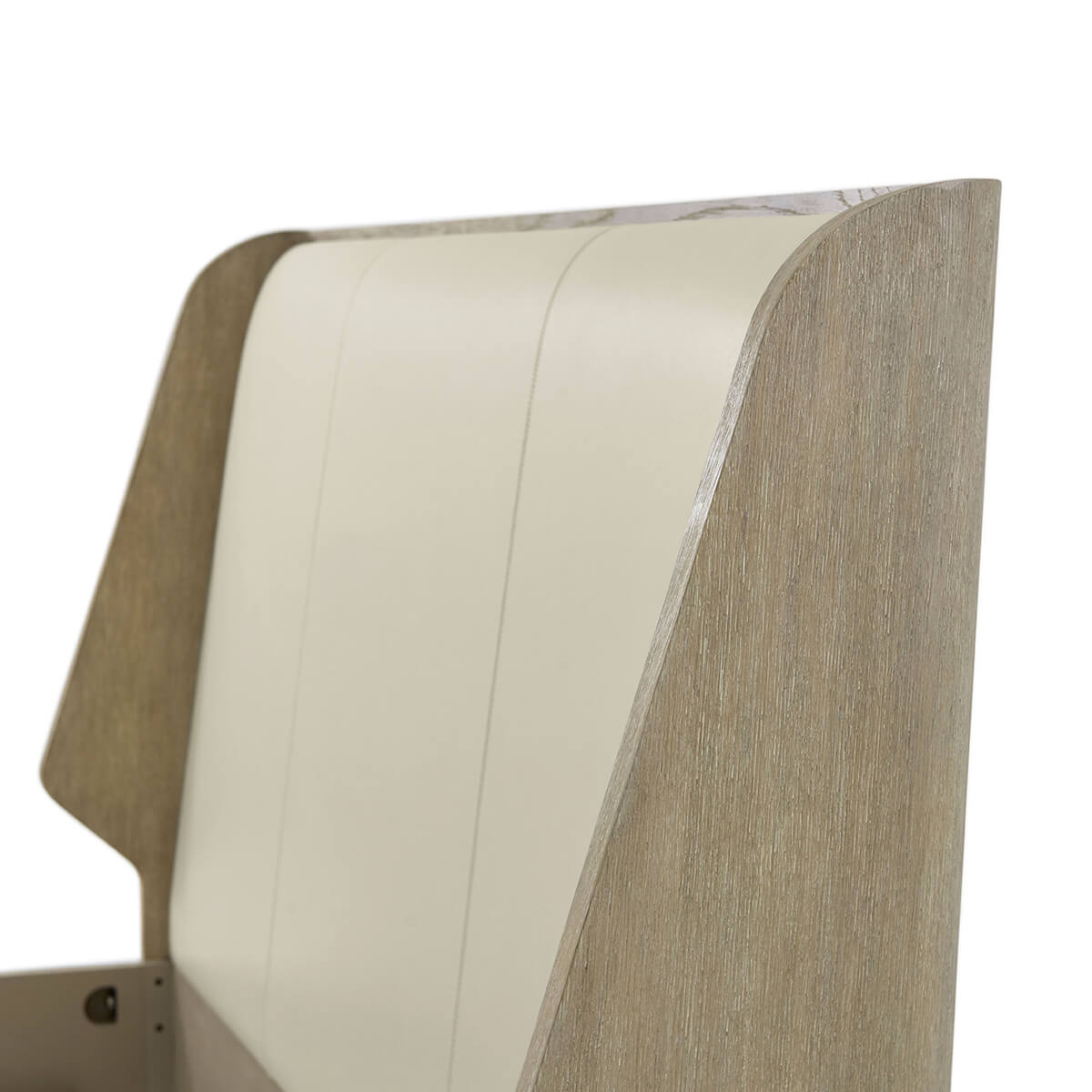 Close-up of oak luxury bed frame headboard design.