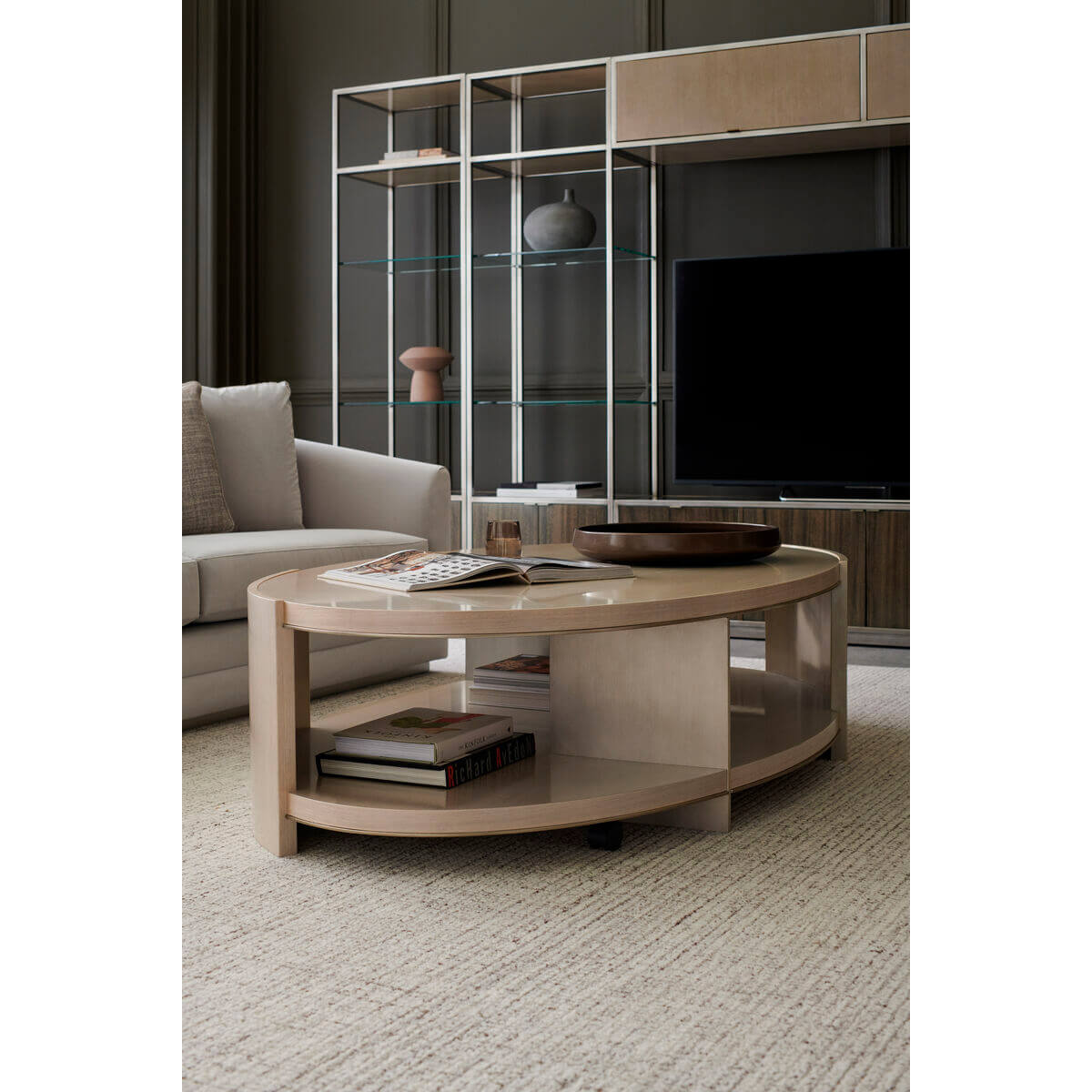 Oval cocktail table with books in elegant living room.