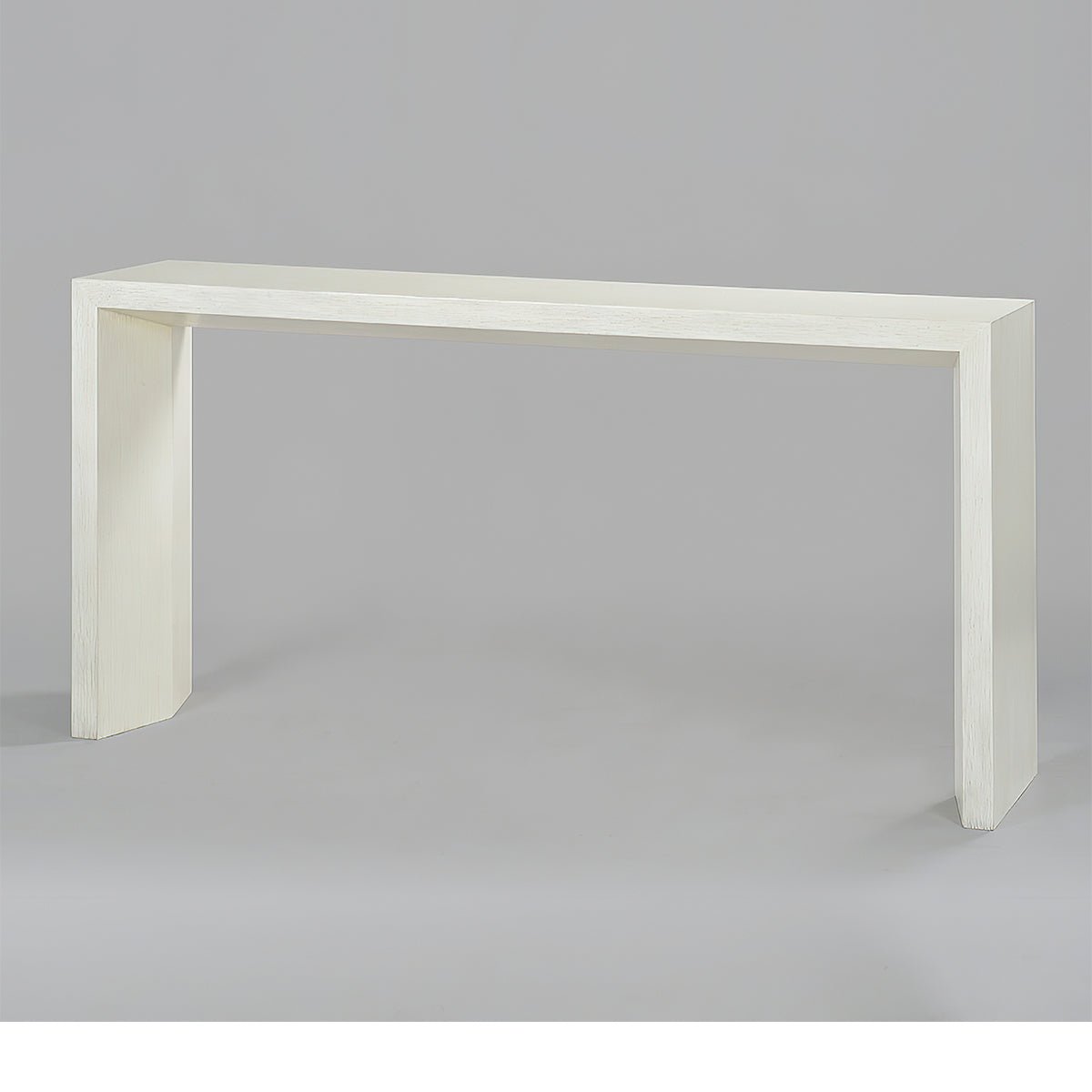 Minimalist console table, side angle on gray background.