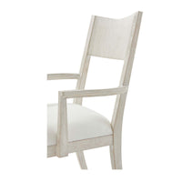 Close-up of armrest and back of dining chair.