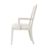 Side profile of white dining armchair.
