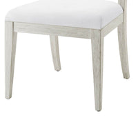 Close-up of chair's wooden legs and seat.