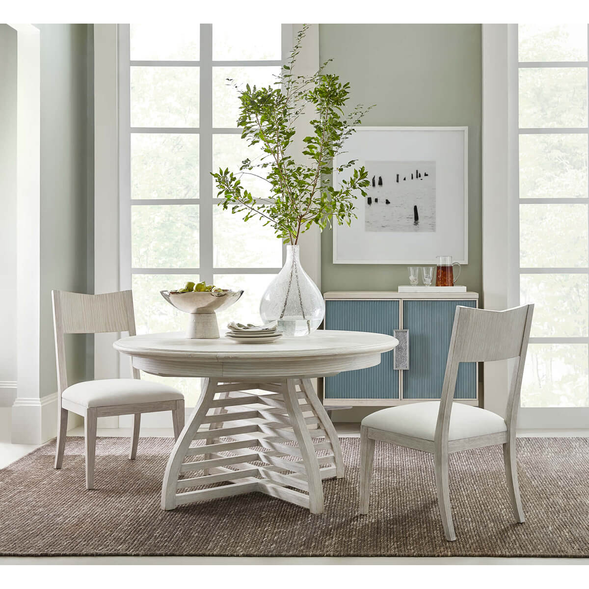 Dining room scene with modern painted dining chairs set.