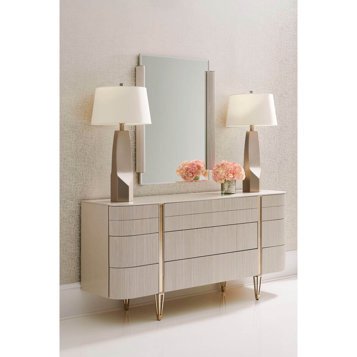 Decorative setup with modern dresser, lamps, mirror.